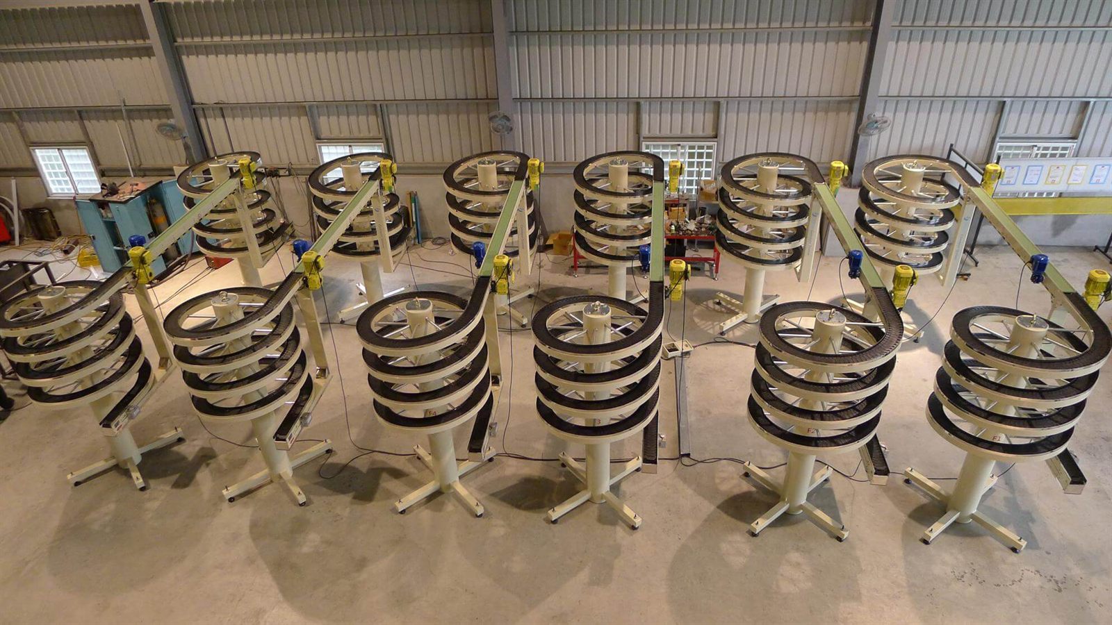 Narrow track spiral conveyors standing on the NEXUS factory floor before shipment.