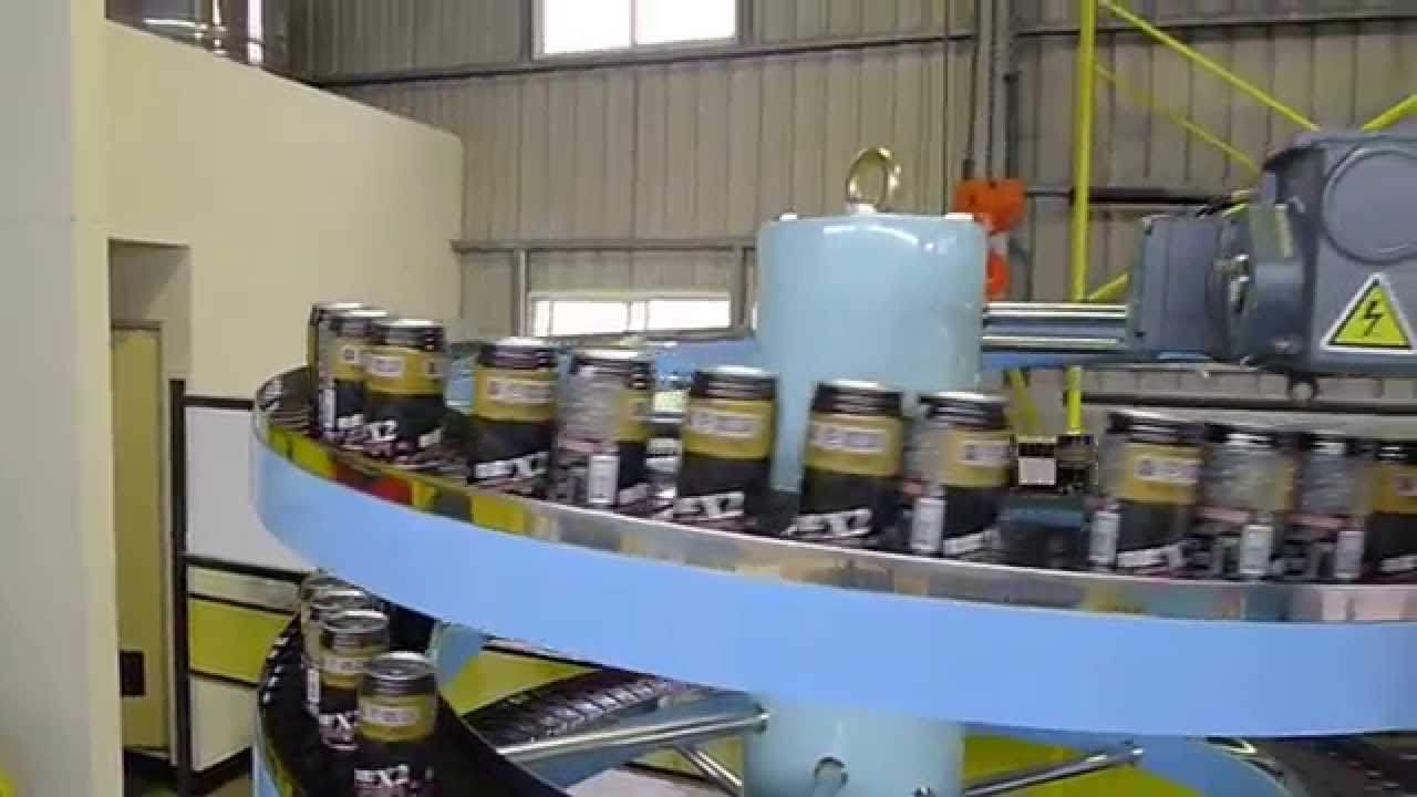 A line of cans travelling on the narrow track of a blue spiral conveyor.