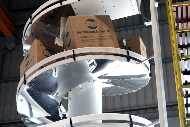 A unit load spiral conveyor carrying cartons.