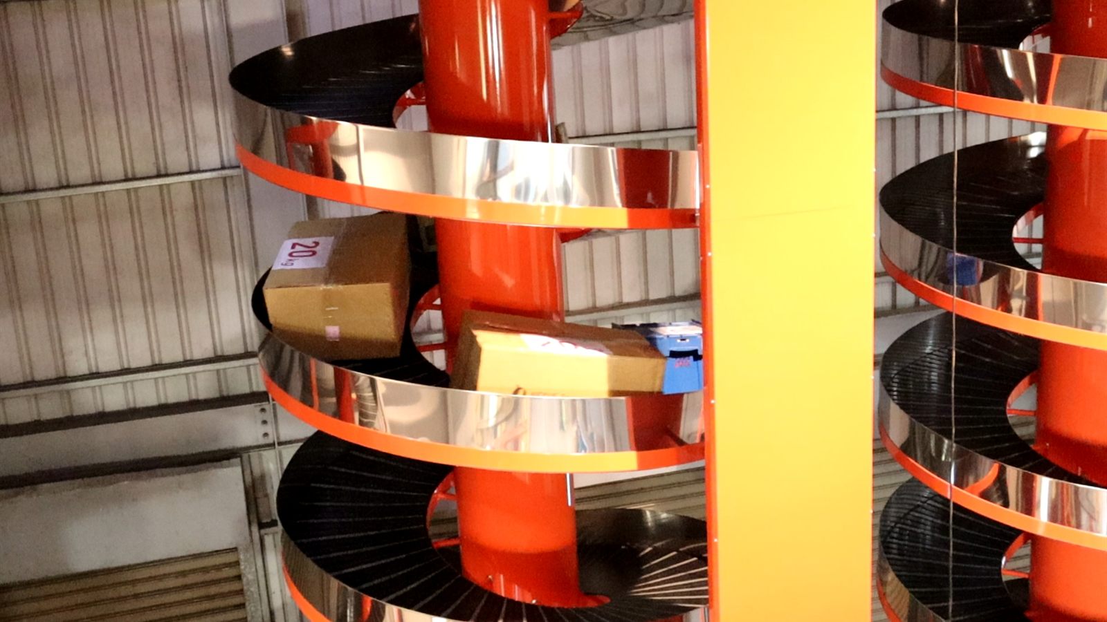 A unit load spiral conveyor carrying cartons in the NEXUS factory.